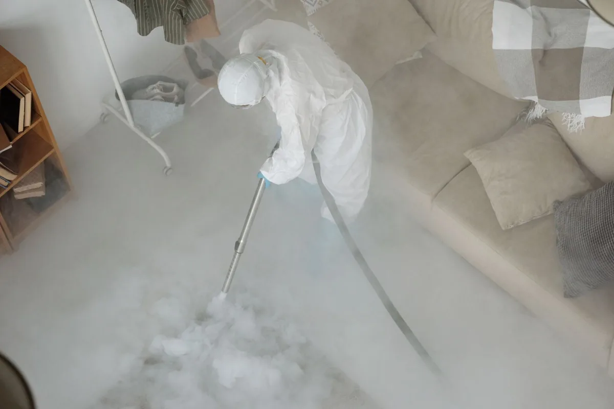 Biohazard cleanup technician in protective equipment, Dillingham, AK